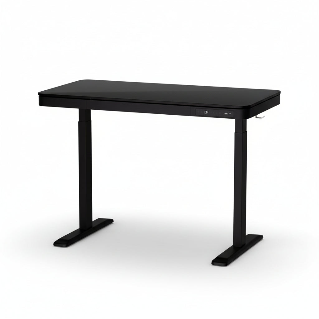 An electrically adjustable standing desk with a black tabletop and black legs, featuring a large storage drawer on the front.