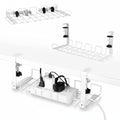 Two white under desk cable management trays with clamp mounting systems, shown attached to a desk frame, with open wire mesh design for cable threading.