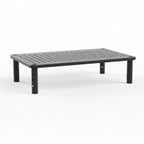 A black metal and plastic monitor laptop stand with a mesh pattern on the surface, with adjustable height settings and four legs.